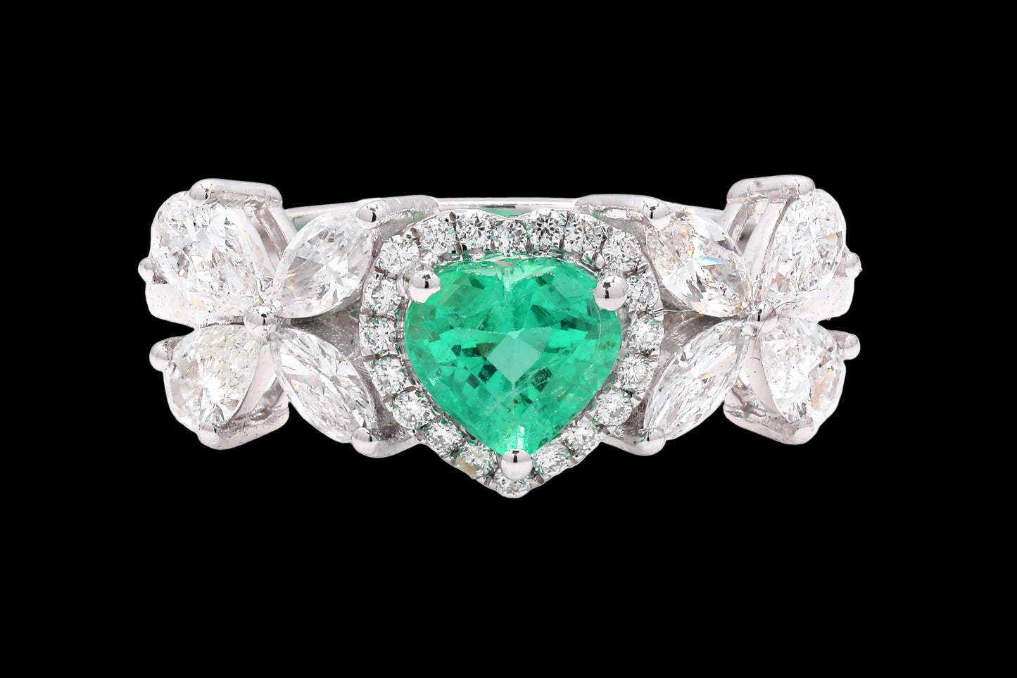 Ring with a heart-shaped emerald and diamond accents on a white background